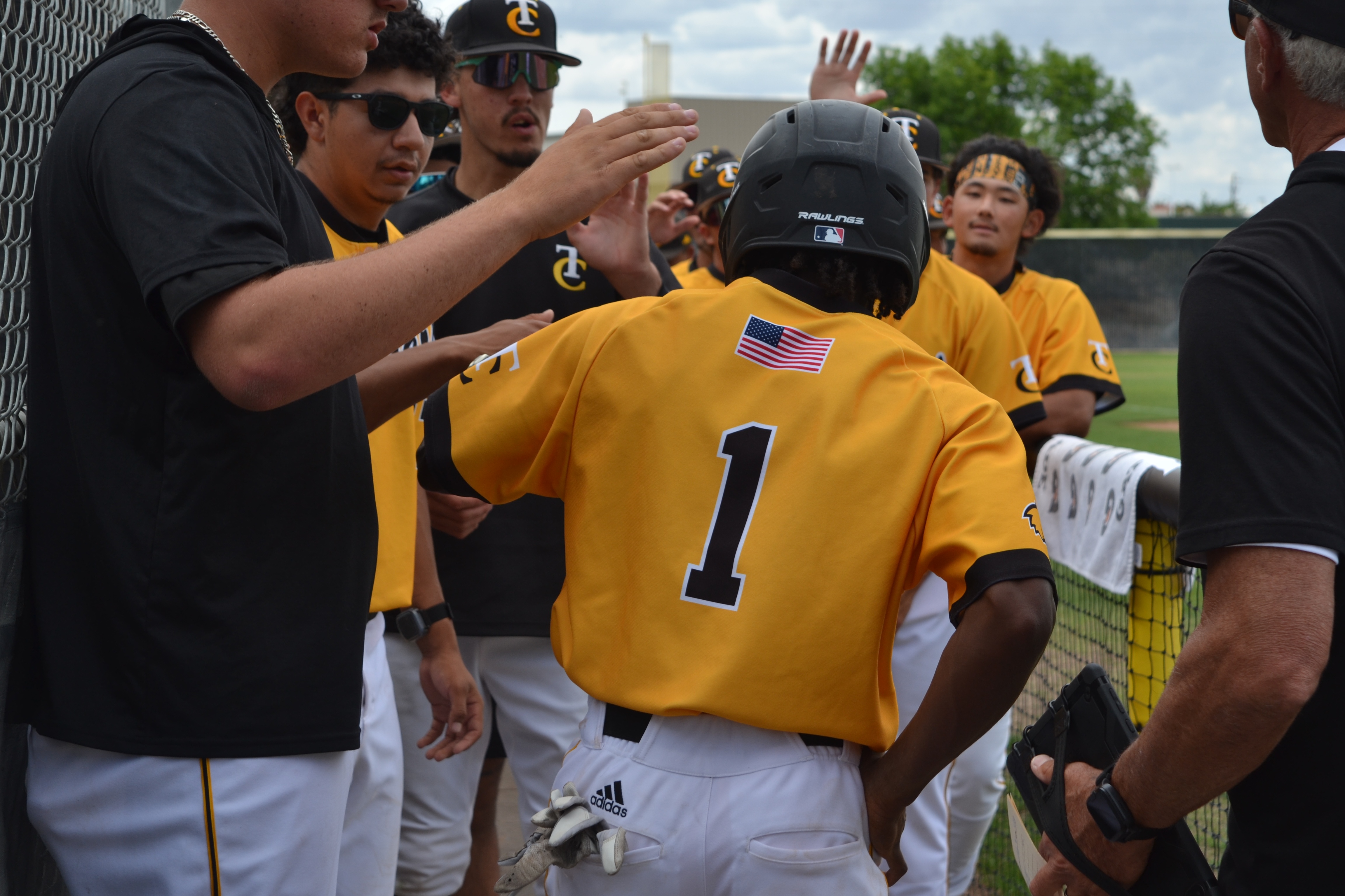 Pictured: #1 William Glover being hi-fived for one of his home runs.