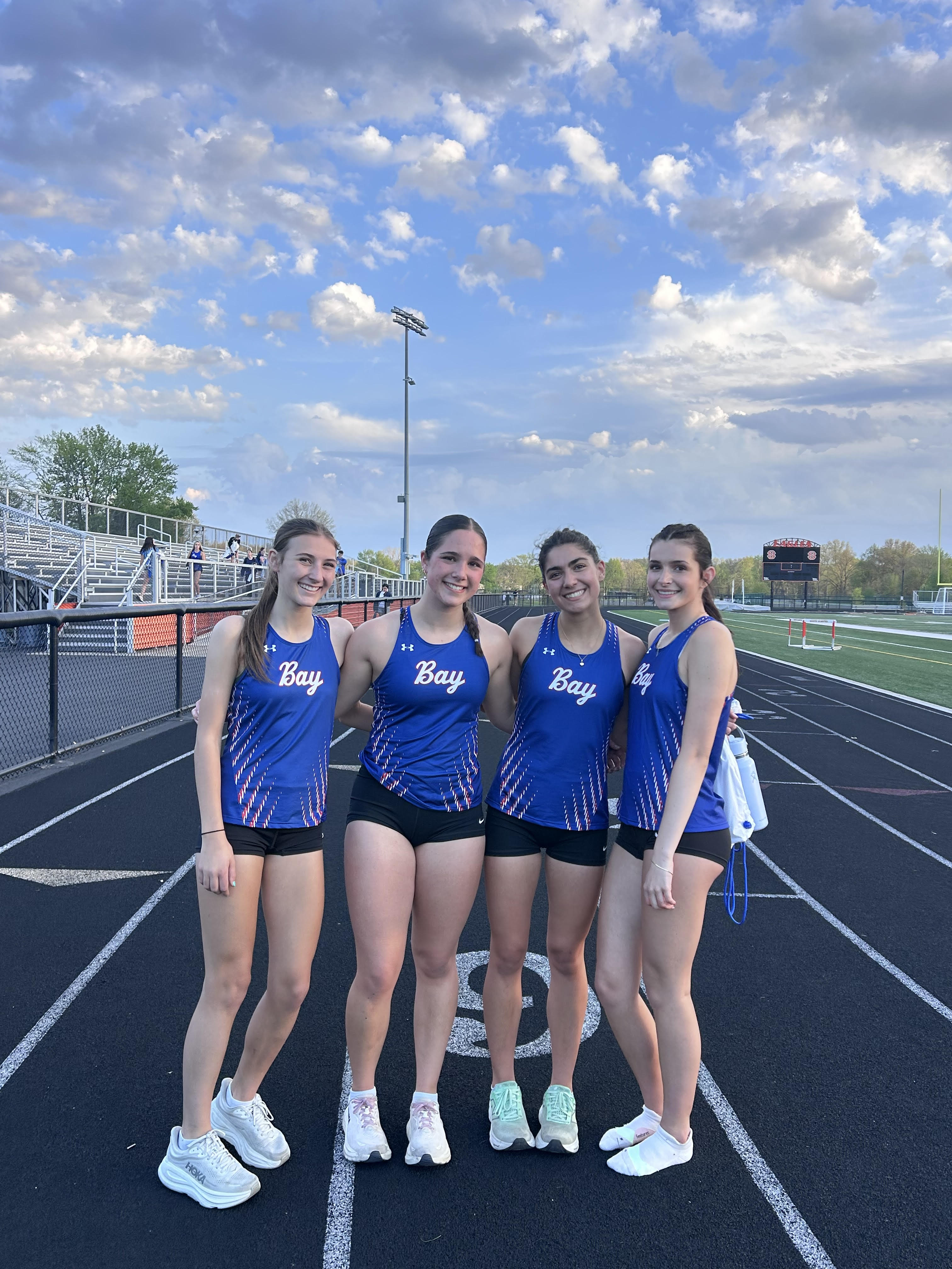 Senior Captain Anne Weber (third from right) with fellow distance runners celebrating her new 3200m Run PR!