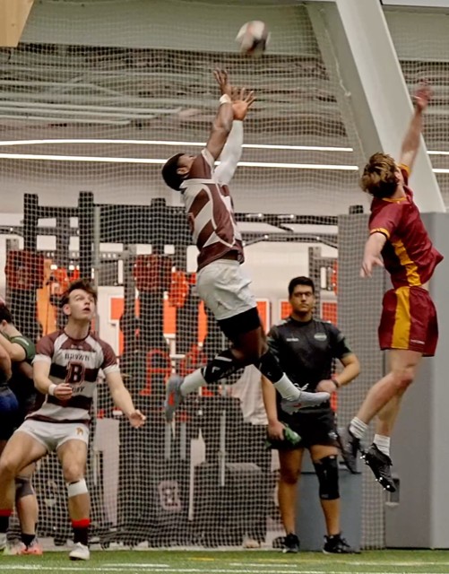 Captain Tito Edjua '27 wins the aerial battle with Cameron Kean '29 in support