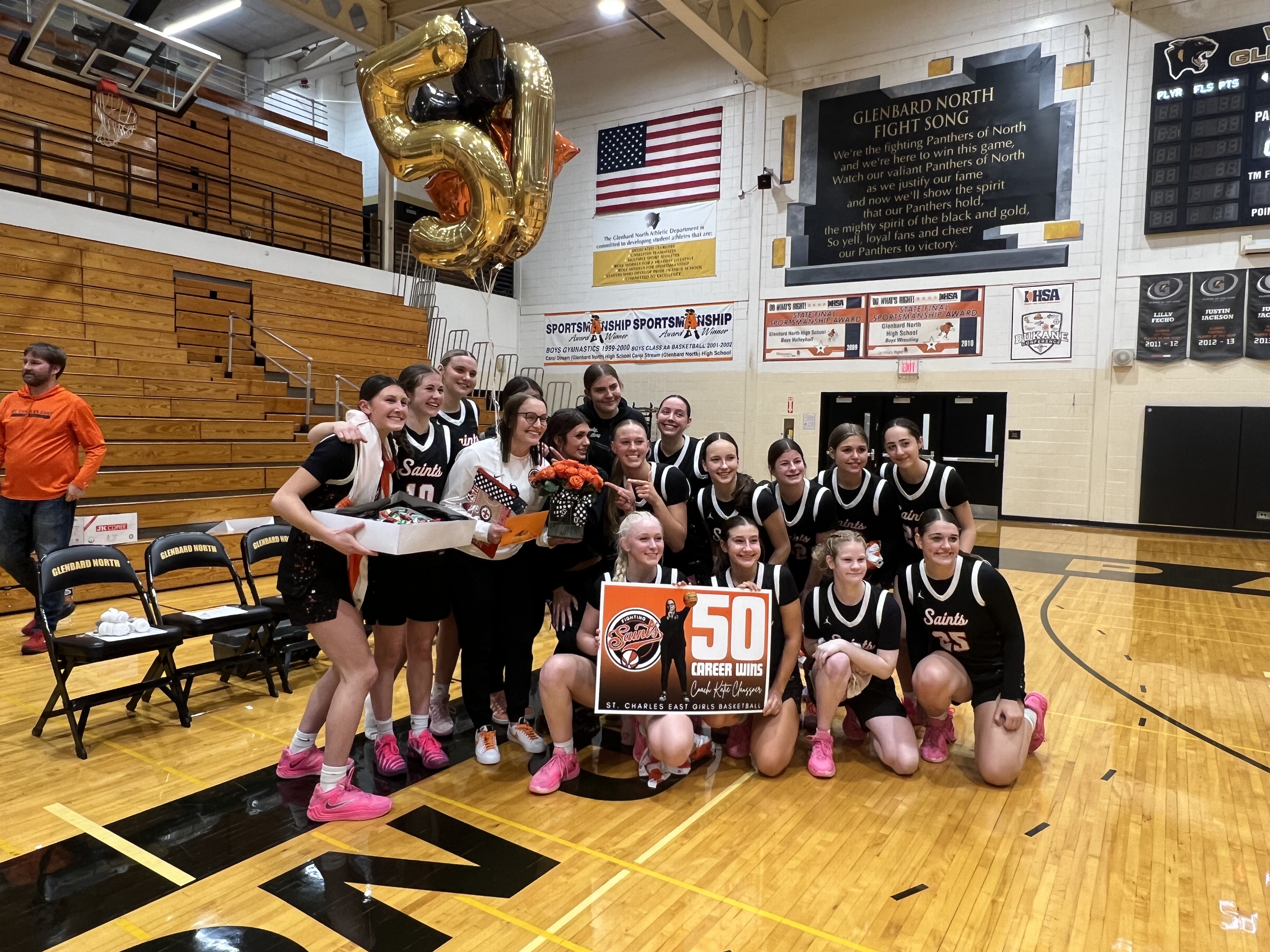 St Charles East Girls' Basketball Team Celebrates Coach Claussner's 50th Career Win Against Glenbard North