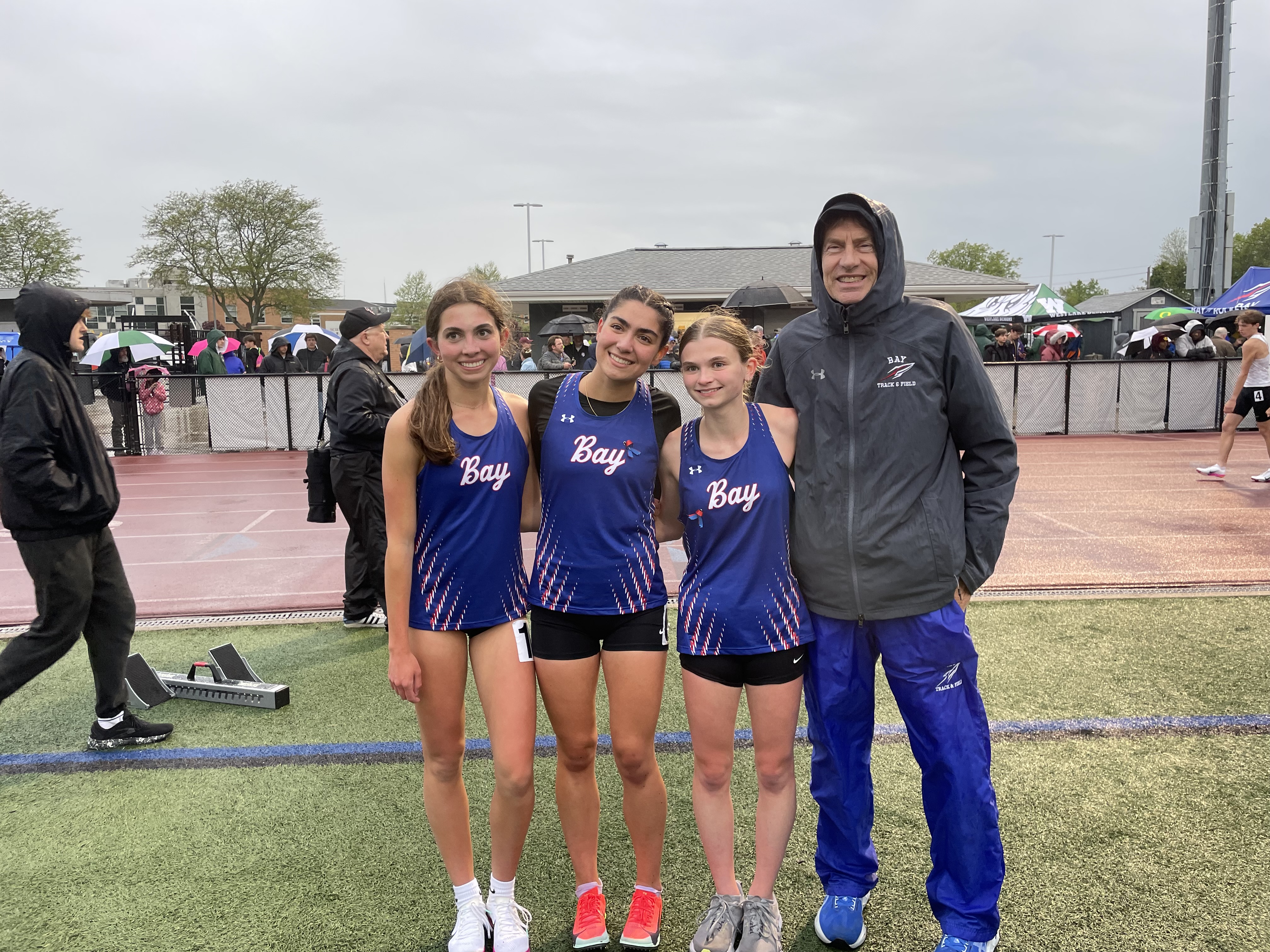 The 1600m trio of Maya Gonzalez, Anne Weber, and Elyse Mull, celebrating their top performances with Coach Snyder!